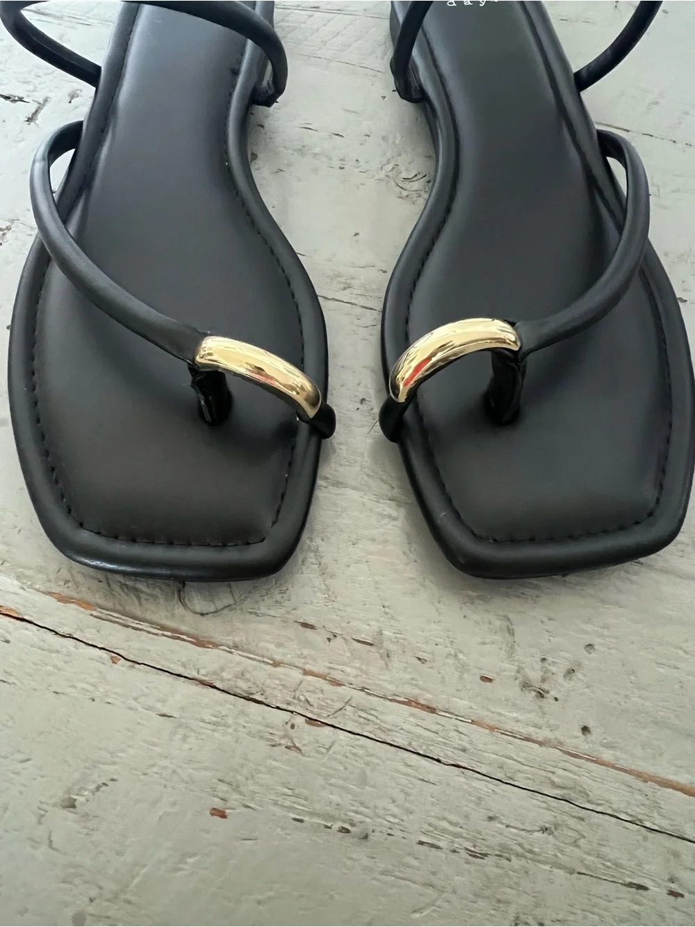 Chic, sleek scrappy sandal with gold accent toe ring